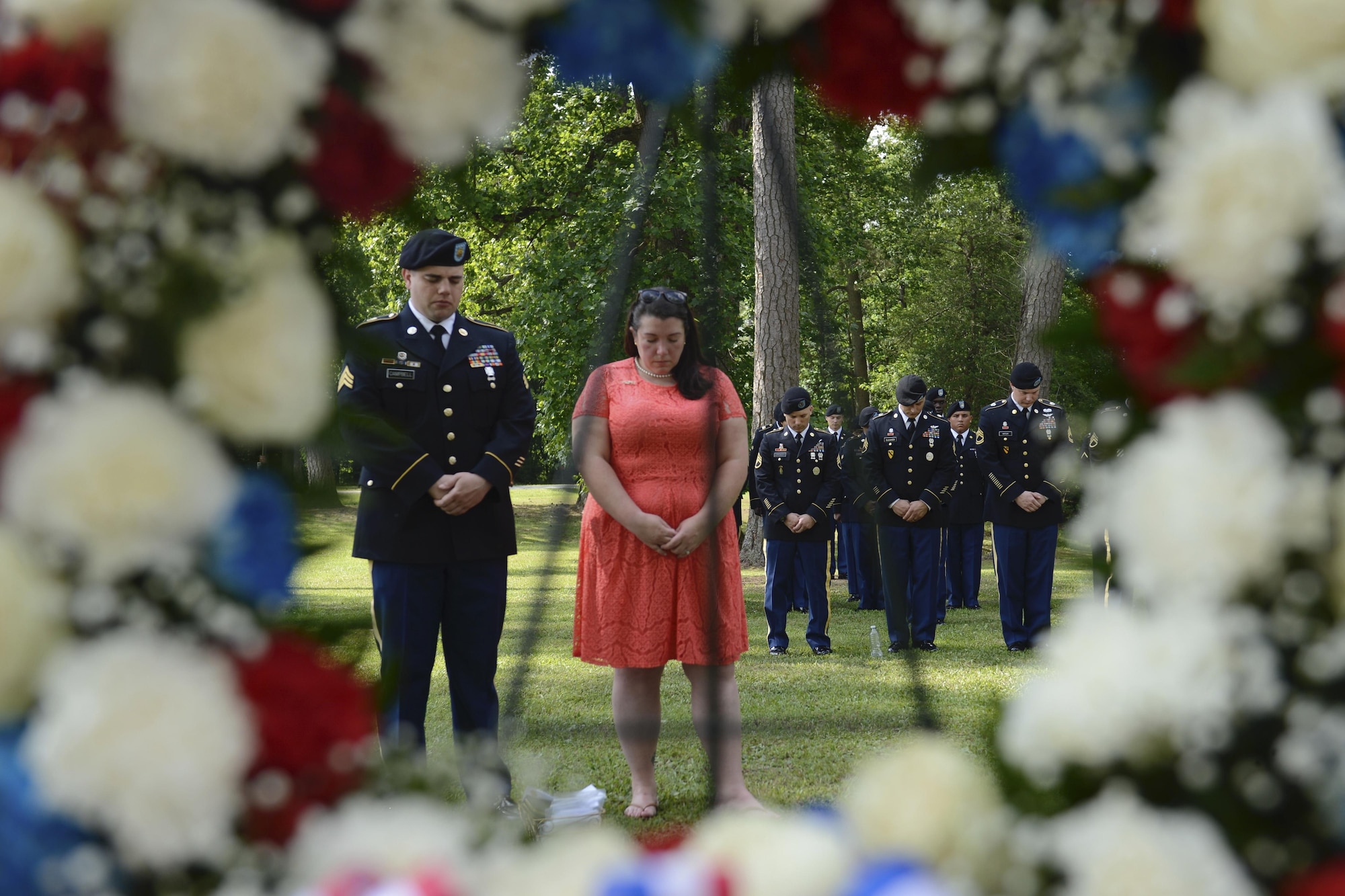 U.S. service members and civilians bow their heads during the invocation at the Bronze Cross Statue Memorial Wreath Laying Ceremony at Joint Base Langley-Eustis, Va., May 20, 2017. The ceremony paid tribute to all the Gold Star families who attended and provided them with a Gold Star lapel pin. (U.S. Air Force photo/Airman 1st Class Kaylee Dubois)