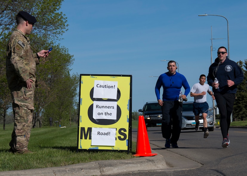 Airmen sprint the end of the 5K Memorial Run during National Police Week at Minot Air Force Base, N.D., May 18, 2017. National Police Week is a congressionally honored week celebrating law enforcement personnel across the nation and around the world who have made the ultimate sacrifice in the line of duty. (U.S. Air Force photo/Airman 1st Class Alyssa M. Akers)