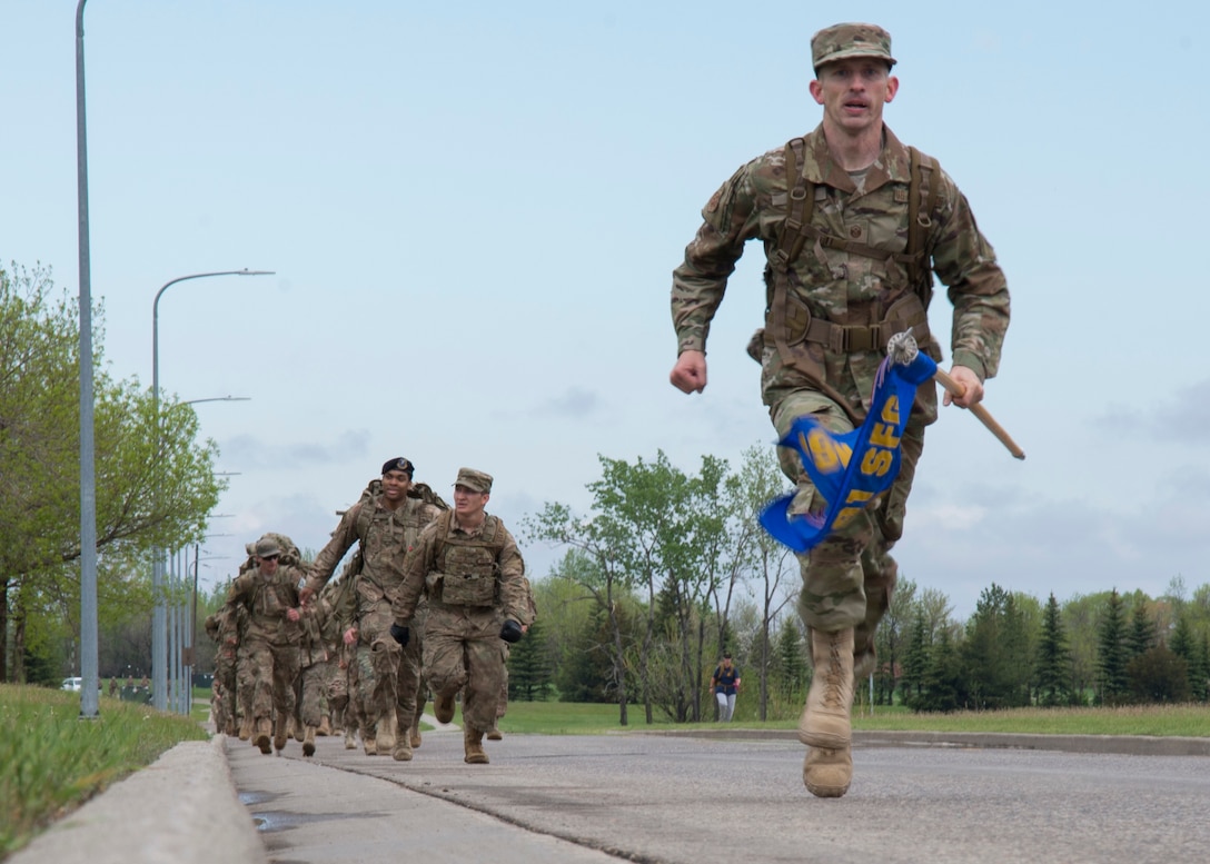 Master Sgt. Christopher Davis, 791st Missile Security Forces Squadron first sergeant, sprints to finish the 5K Remembrance Ruck March at Minot Air Force Base, N.D., May 16, 2017. Members who finished first turned around to motivate the group to finish strong together. (U.S. Air Force photo/Airman 1st Class Alyssa M. Akers)