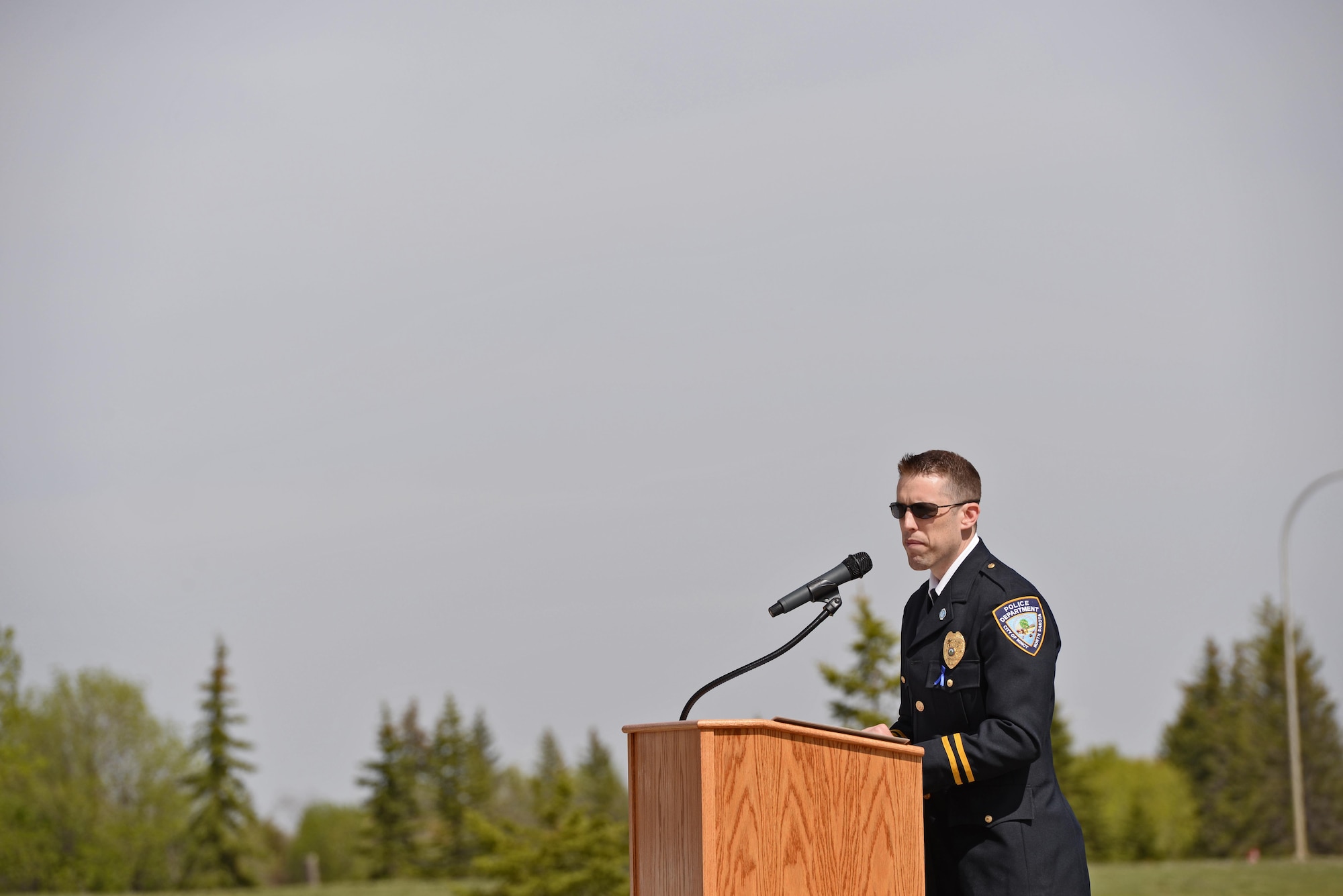 Police Officer Justin Sundheim, captain of the Minot Police Department, recites fallen officers’ names at the National Police Week retreat ceremony at Minot Air Force Base, N.D., May 19, 2017. Retreat is the last ceremony of National Police Week. (U.S. Air Force photo/Airman 1st Class Austin M. Thomas)