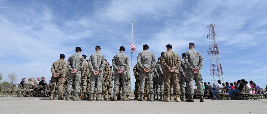 Airmen with the 5th Security Forces Squadron stand at parade rest during the National Police Week retreat ceremony at Minot Air Force Base, N.D., May 19, 2017. During National Police Week, many ceremonies, competitions and demonstrations are held by law enforcement organizations for ceremonial reasons, patriotic tributes and public viewing. (U.S. Air Force photo/Airman 1st Class Austin M. Thomas)