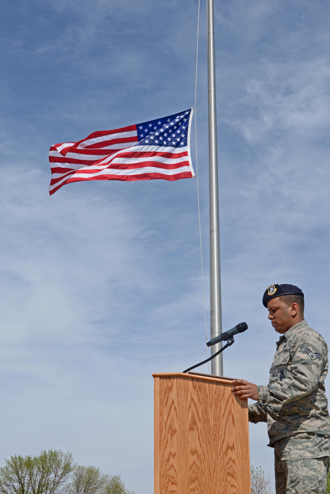 Senior Airman Eduardo Virgil, 5th Security Forces Squadron desk sergeant, recites fallen officers’ names during a National Police Week retreat ceremony at Minot Air Force Base, N.D., May 19, 2017. A retreat ceremony is the daily military practice of lowering the flag. (U.S. Air Force photo/Airman 1st Class Austin M. Thomas)