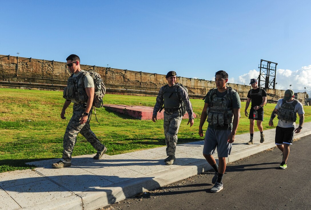 Joint Base Security Forces (JBSF) Airmen march around Hickam Field during the Police Week Ruck March, on Joint Base Pearl Harbor-Hickam, Hawaii, May 19, 2019. According to the National Peace Officer’s Memorial Fund website, National Police Week was established in 1962 by President John F. Kennedy to pay tribute to law enforcement officers who lost their lives in the line of duty. Ceremonies and observances are held annually throughout the U.S. in remembrance of fallen officers.  (U.S. Air Force photo by Tech. Sgt. Heather Redman)