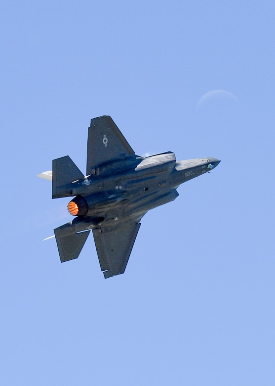 An F-35A Lightning II takes its show to the moon during the 2017 Star Spangled Salute air show at Tinker AFB May 21.  The joint strike fighter was one of more than 50 statics and aerial acts on display for the airshow as record crowds helped Tinker celebrate its 75th anniversary as well as the Air Force 70th birthday.  (U.S. Air Force photo/Mark Hybers)