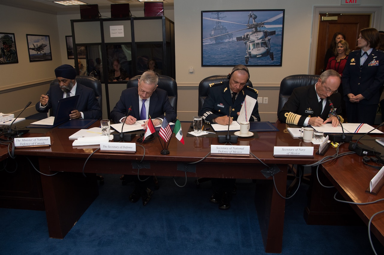 Defense Secretary Jim Mattis signs a joint statement with other defense leaders after hosting the third North American Defense Ministerial meeting at the Pentagon, May 22, 2017. From left to right are Canadian Defense Minister Harjit Sajjan, Mattis, Mexican Defense Secretary Gen. Cienfuegos Zepedas and Mexico's secretary of navy, Adm. Vidal Soberón. DoD photo by Army Sgt. Amber I. Smith