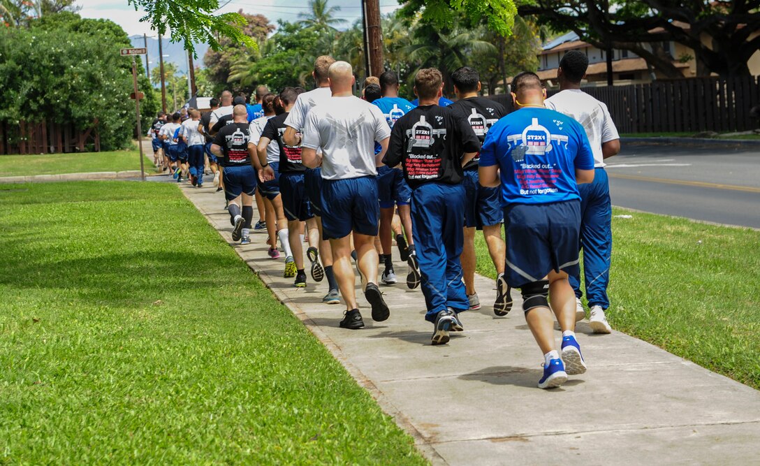 Air transportation Airmen from Joint Base Pearl Harbor-Hickam participate in a Port Dawg Memorial 5K run on Hickam Field, Hawaii, May 19, 2017.  The run was part of a coordinated event with other air transportation units around the world to honor ‘port dawg’ Airmen who have passed away. (U.S. Air Force photo by Tech. Sgt. Heather Redman)