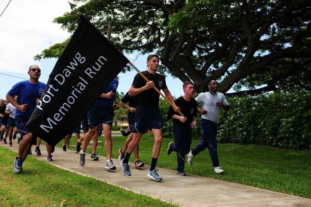 Air transportation Airmen from Joint Base Pearl Harbor-Hickam participate in a Port Dawg Memorial 5K run on Hickam Field, Hawaii, May 19, 2017.  The run was part of a coordinated event with other air transportation units around the world to honor ‘port dawg’ Airmen who have passed away. (U.S. Air Force photo by Tech. Sgt. Heather Redman)