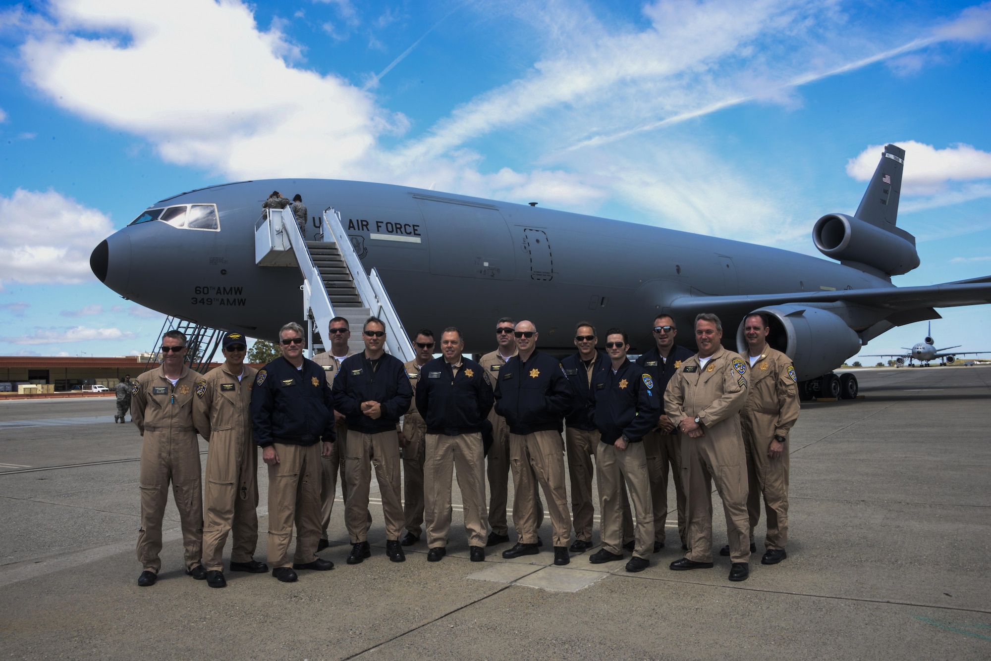 Members of the California Highway Patrol  pose in front of a KC-10 Extender May 11 at Travis Air Force Base, California. The CHP joined the 6th and 9th Air Refueling Squadrons on a KC-10 training flight, where they were able to watch air refueling and learn more about the base mission. (U.S. Air Force photo / 2nd Lt. Sarah Johnson)