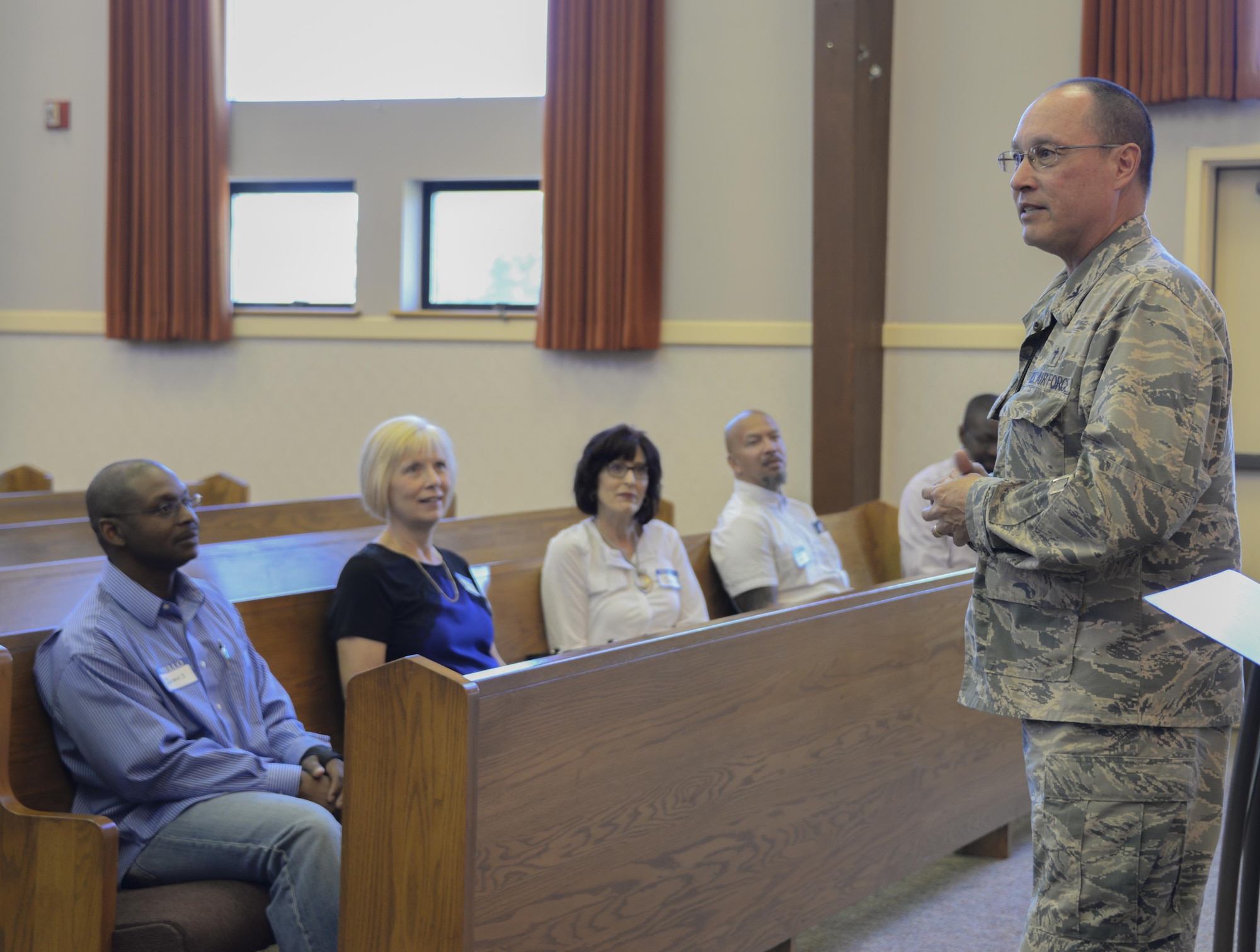Col. Kenneth Reyes, 60th Air Mobility Wing head chaplain, interacts with local clergy members during Clergy Day May 18 at Travis Air Force Base, Calif. The purpose of the event was to inform and educate leaders from off-base religious services from a variety of faiths about life at Travis, particularly for children and young Airmen in their teens and early 20s.
