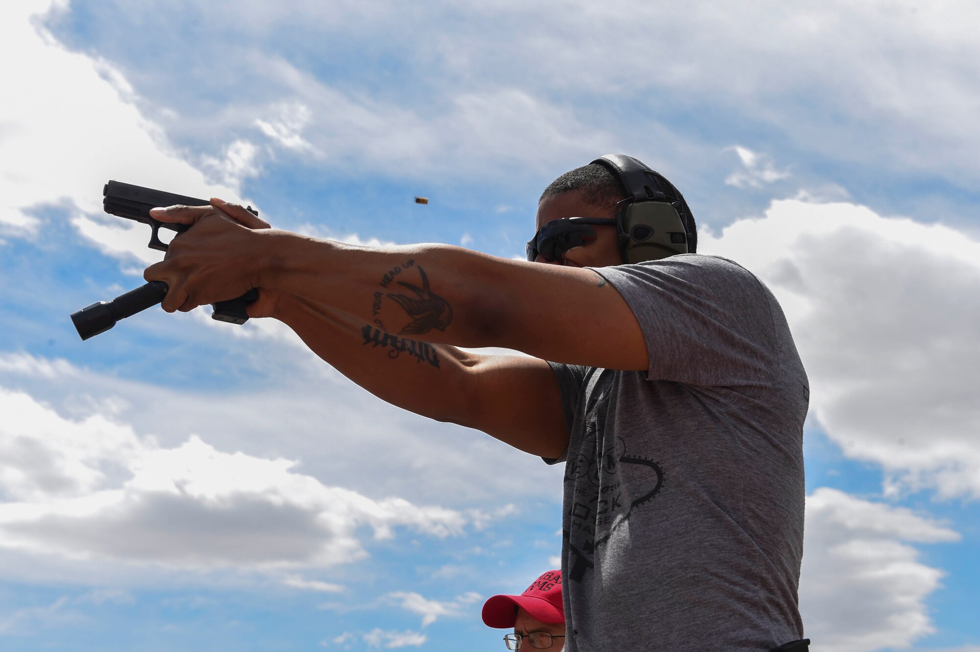 Staff Sgt. Clifford fires his weapon at Station Four during the Nellis/Creech Law Enforcement Pistol Shoot as part of Police Week May 15, 2016, at Silver Flag Alpha, Nev. National Police Week takes place annually to honor the service and sacrifice of civilian and military law enforcement members. (U.S. Air Force photo Airman 1st Class Adarius Petty)