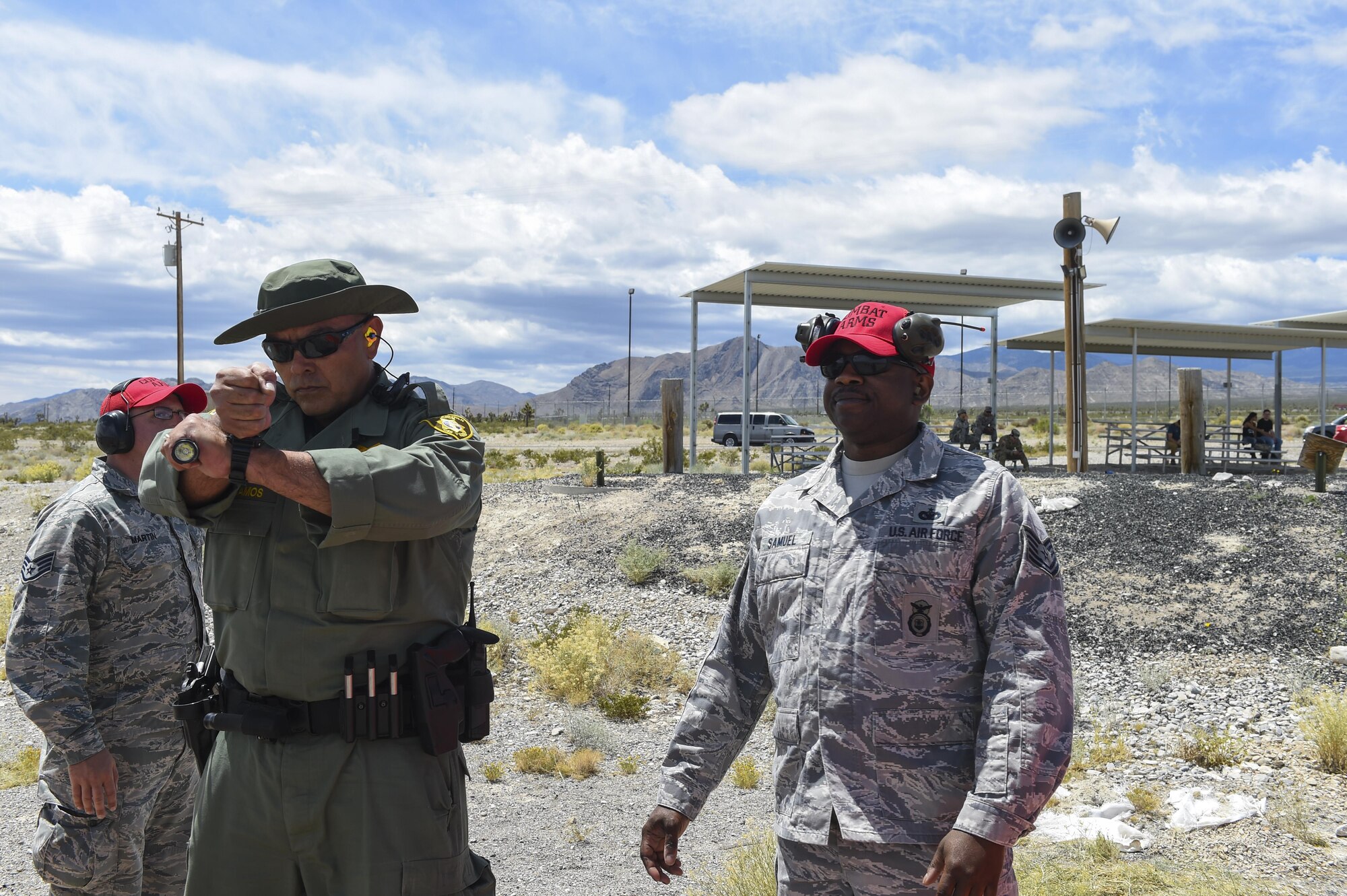 Tech Sgt. Errol 799th Security Forces Combat Arms Training and Maintenance instructor helps Metropolitan Police Officer Ramos prepare for his shooting course May 15, 2016, at Silver Flag Alpha, Nev. Air Force Security Forces and local law enforcement came together for National Police Week to honor the service and sacrifice of civilian and military law enforcement members. (U.S. Air Force photo Airman 1st Class Adarius Petty)