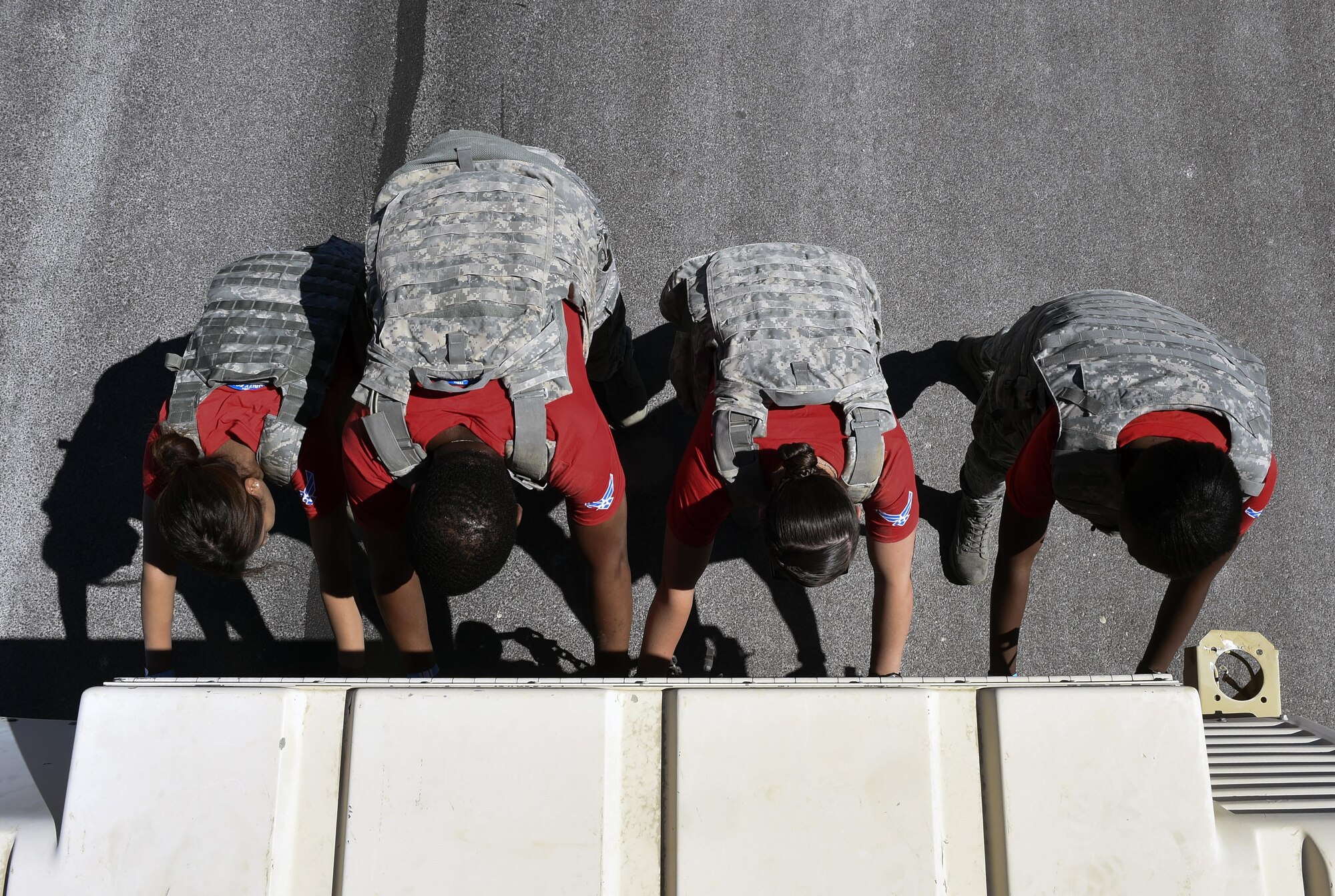 A 799th Security forces team pushes a Humvee at the Warrior Fitness Challenge in support of Police Week May 15, 2016, Creech Air Force Base, Nev. National Police Week takes place annually to honor the service and sacrifice of civilian and military law enforcement members. (U.S. Air Force photo Airman 1st Class Adarius Petty)