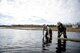 U.S. Air Force Airman 1st Class Augustus Hawkins, a 354th Civil Engineer Squadron pavement and construction equipment operator, submerges a hose in a pool of water April 10, 2017, at Eielson Air Force Base, Alaska. When the snow starts to melt water pools up on different areas of the base and has to be pumped to prevent potential damage to infrastructure. (U.S. Air Force photo by Airman 1st Class Isaac Johnson) 