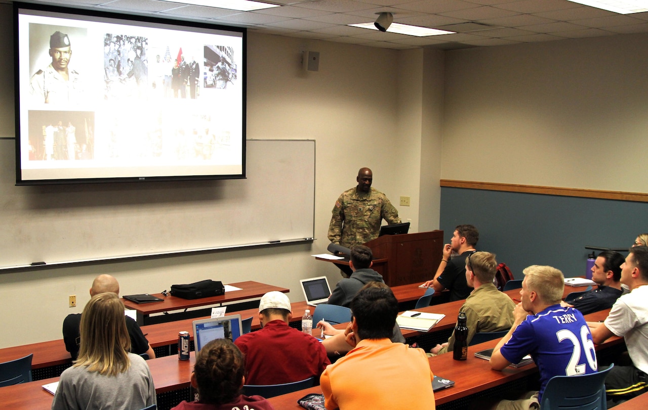 Col. Oscar Doward, Jr., commander, 2503rd Digital Liaison Detachment, U.S. Army Central, gives a lesson to students on African-American Soldiers and their participation in World War I at the University of South Carolina, Columbia.  Doward is one of 60 officers participating in the Advanced Strategic Planning and Policy Program that helps produce strategic planners and future senior leaders through a doctorate program. (U.S. Army Photo by Staff Sgt. Jared Crain)