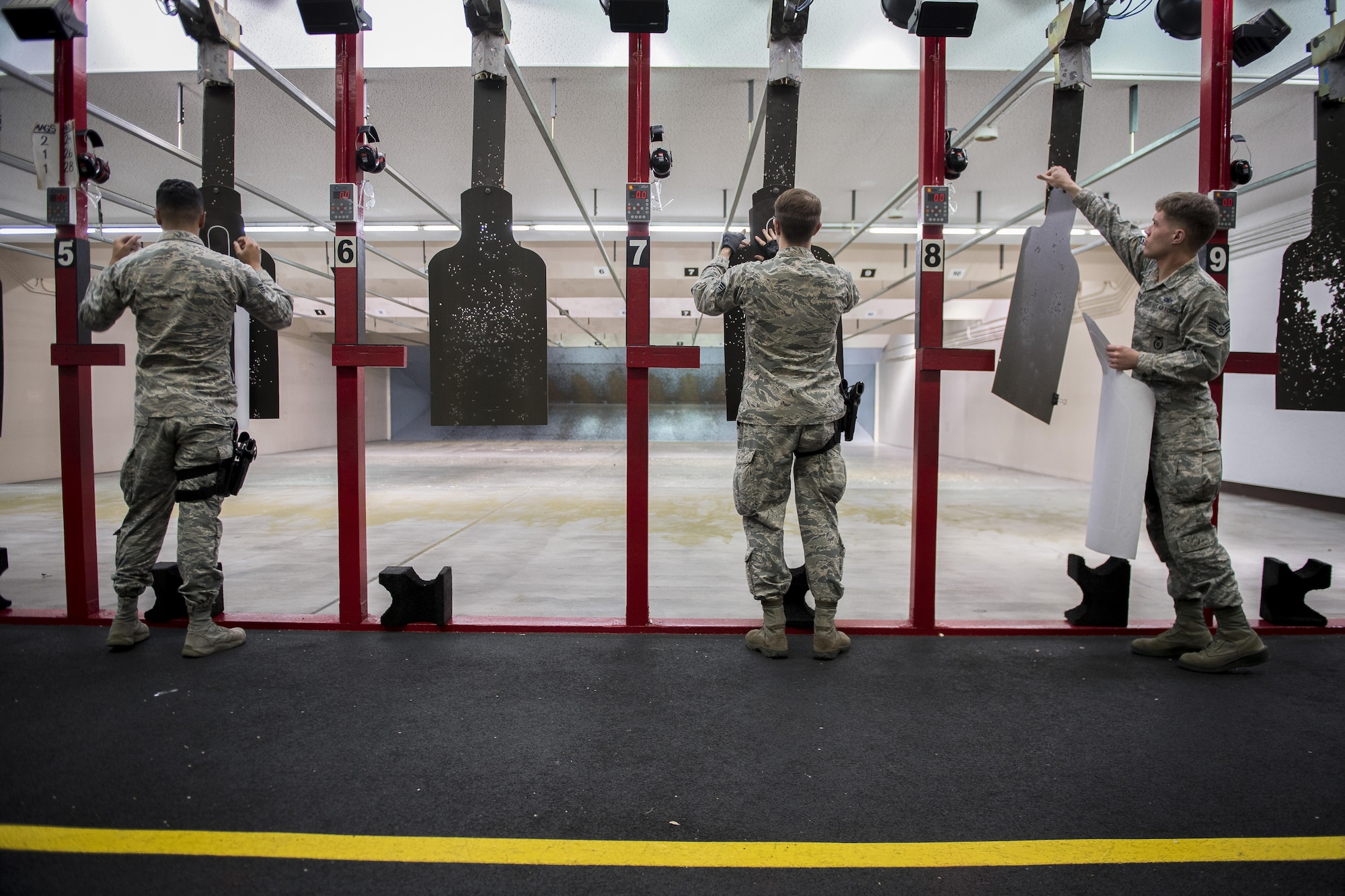 374th Security Forces Squadron members prepare the firing range prior to a Police Week shooting competition, May 16, 2017, at Yokota Air Base, Japan. The winner of the competition received a trophy and bragging rights as the 374 SFS top shooter. (U.S. Air Force photo by Airman 1st Class Donald Hudson)