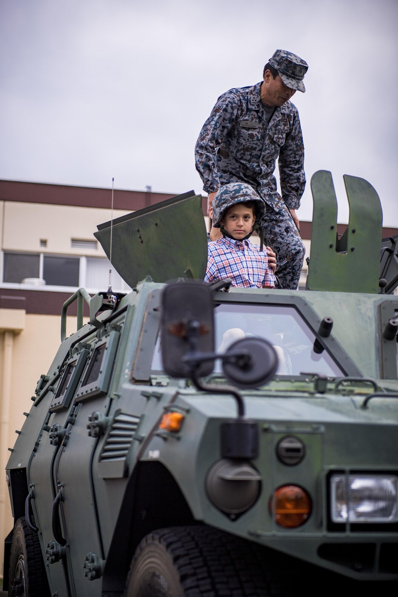 A child poses for a photograph in a Japan Air Self Defense Force vehicle during a Police Week event, May 17, 2017, at Yokota Air Base, Japan. The event included various static displays from the Tokyo Police Department, JASDF, 374th Security Forces Squadron and U.S. Office of Special Investigations. (U.S. Air Force photo by Airman 1st Class Donald Hudson)