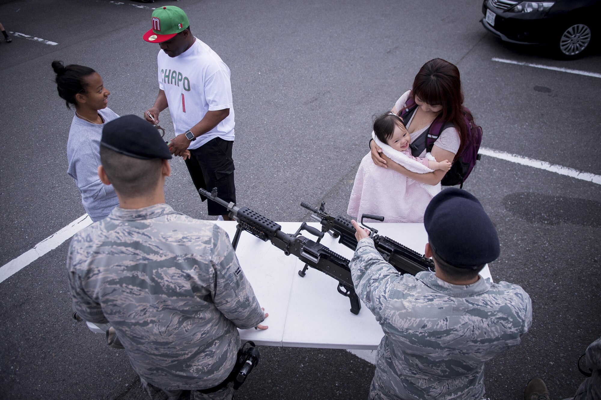 374th Security Forces Squadron members show event goers the equipment they use during a Police Week event, May 17, 2017, at Yokota Air Base, Japan. The event included displays and demonstrations of various vehicles, weapons and tools used by U.S. and Japanese law enforcement. (U.S. Air Force photo by Airman 1st Class Donald Hudson)