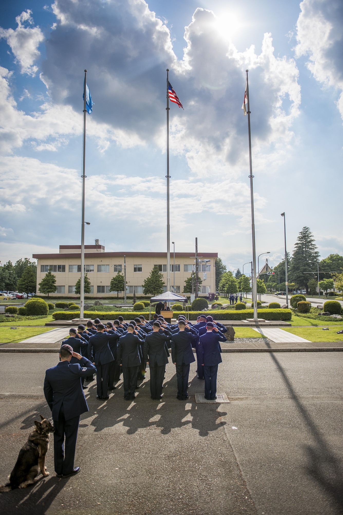 374th Security Forces Squadron members stand in formation and salute the flag during a memorial retreat ceremony for fallen law enforcement members, May 18, 2017, at Yokota Air Base, Japan. The memorial service included a ceremony recalling the names of U.S. Air Force Security Forces members who died in the line of duty since Operation Enduring Freedom. (U.S. Air Force photo by Airman 1st Class Donald Hudson)