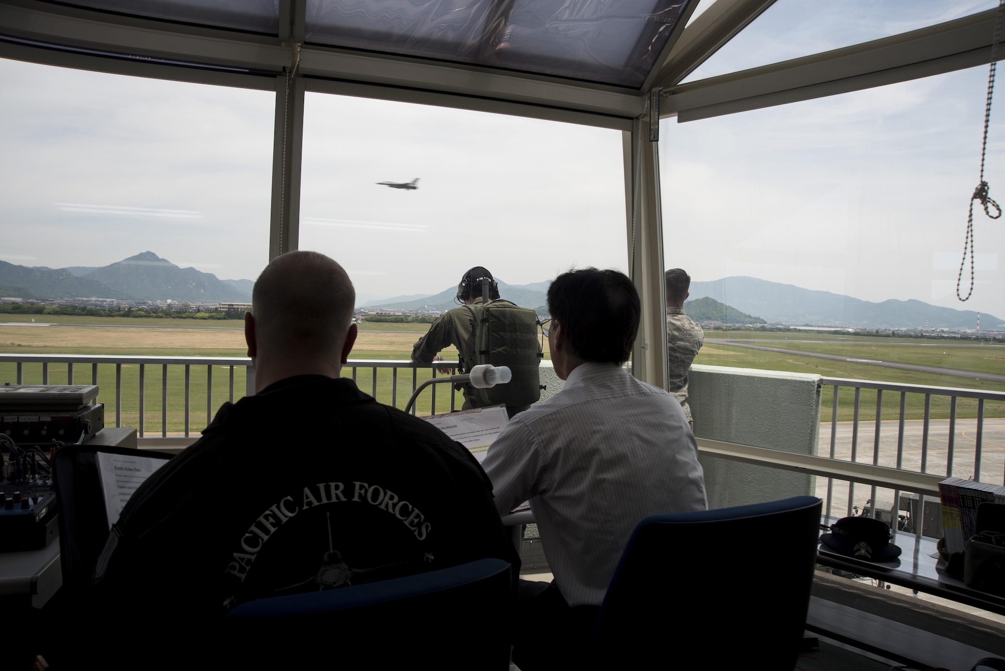 Members of the Pacific Air Forces F-16 Demonstration Team watch as an F-16 Fighting Falcon flies by during the Hofu Air Festival at Hofu-kita Air Base, Japan, May 21, 2017. The team's purpose is to strengthen the U.S. relationship with countries in the Pacific region through demonstrations showing the pinnacle of the Air Force core values of integrity, service and excellence. (U.S. Air Force photo by Staff Sgt. Melanie Hutto)