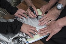 U.S. Air Force Capt. Dakota Newton, the Pacific Air Forces F-16 Demonstration Team safety observer, signs an umbrella for a Japanese local during the Hofu Air Festivalat at Hofu-kita Air Base, Japan, May 21, 2017. While their primary focus is to showcase the jet’s capabilities, community engagement plays a big role. For some of the air festival attendees, this was their first interactions with Americans. (U.S. Air Force photo by Staff Sgt. Melanie Hutto)
