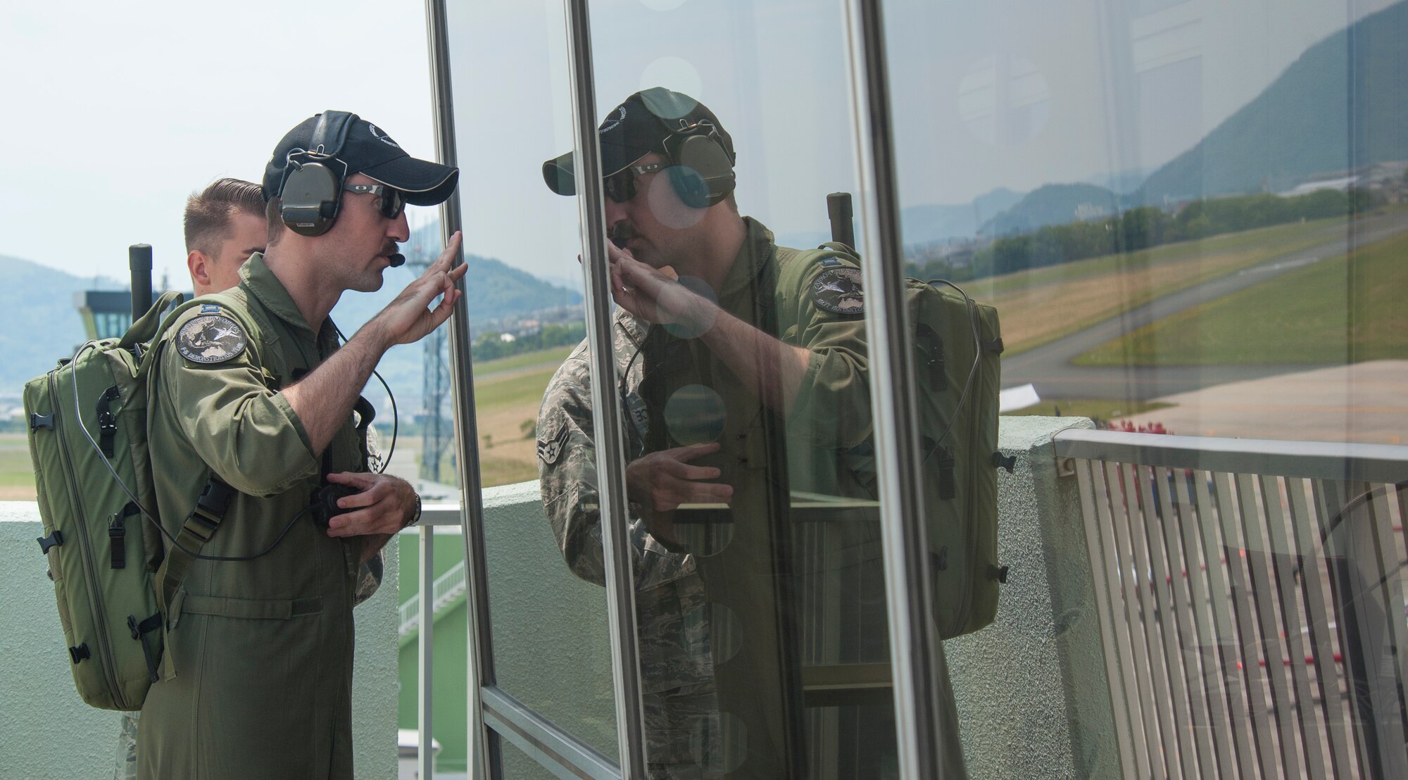 U.S. Air Force Capt. Dakota Newton, the Pacific Air Forces F-16 Demonstration Team safety observer, signals to the announcers the F-16 Fighting Falcon demo pilot will begin the performance in 30 seconds during the Hofu Air Festival at Hofu-kita Air Base, Japan, May 21, 2017. As safety observer, Newton is Maj. Richard Smeeding’s eyes on the ground, ensuring he is set up for the next maneuver properly and making sure there are no birds in his path. Smeeding is the demo pilot. Besides the show schedule, team members must be ready to deploy in support of the 35th Fighter Wing's wartime mission while handling their day-to-day jobs within the squadron. (U.S. Air Force photo by Staff Sgt. Melanie Hutto)