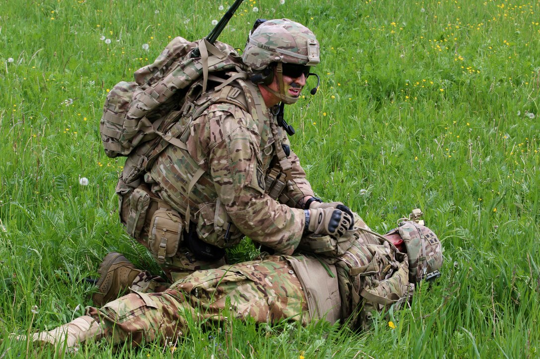 A soldier provides medical aid to a mock casualty while participating in air medical evacuation training in Grafenwoehr, Germany, May 22, 2017. The soldiers are assigned to 2nd Battalion, 12th Infantry Regiment. Army photo by Staff Sgt. Kathleen V. Polanco