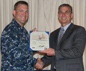 VIRGINIA BEACH, Va.  (May 18, 2017) - Bobby Starks is awarded a certificate of retirement from federal service by Cmdr. Andrew J. Hoffman, Commanding Officer of Combat Direction Systems Activity Dam Neck. Starks retired after more than 34 years as a Navy civilian.