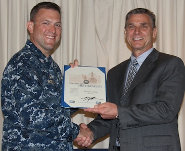 VIRGINIA BEACH, Va.  (May 18, 2017) - Bobby Starks is awarded a certificate of retirement from federal service by Cmdr. Andrew J. Hoffman, Commanding Officer of Combat Direction Systems Activity Dam Neck. Starks retired after more than 34 years as a Navy civilian.