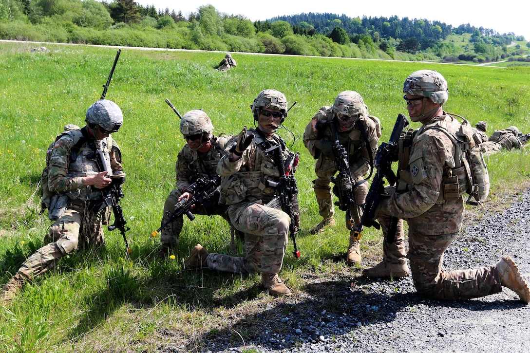 A soldier provides directions to team members for their next objective while participating in air medical evacuation training in Grafenwoehr, Germany, May 22, 2017. Army photo by Staff Sgt. Kathleen V. Polanco