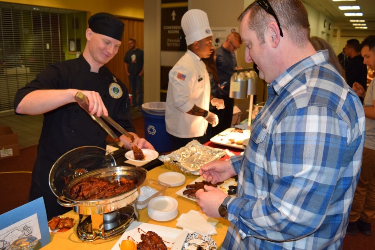 Navy Petty Officer 2nd Class Christopher Wojcik of Naval Hospital Bremerton, Wash., provides samples of his barbecue ribs during the 69th Annual Armed Forces Festival’s Culinary Arts Competition, May 6, 2017. Wojcik, from Grants Pass, Oregon, was awarded first place for his ribs recipe. Navy photo by Douglas H. Stutz