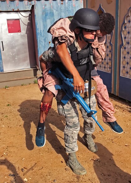 Senior Airman Jessica Penn, a 919th Special Operations Medical Squadron aeromedical technician, transports a simulated wounded patient to a safer area to receive care during the Tactical Combat Casualty Care exercise at Naval Medical Center Balboa in San Diego, Calif.  The TCCC helped the Duke Field medics hone their wartime readiness skills in a highly challenging combat environment. (Courtesy photo).