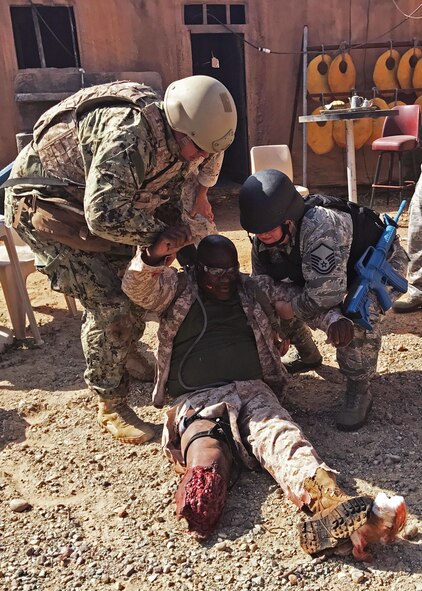 Master Sgt. Michele Godwin, a 919th Special Operations Medical Squadron aeromedical technician, right, teams with a Navy counterpart to transport a simulated wounded patient to a safer area to receive care during the Tactical Combat Casualty Care exercise at Naval Medical Center Balboa in San Diego, Calif. The TCCC helped the Duke Field medics hone their wartime readiness skills in a highly challenging combat environment. (Courtesy photo)