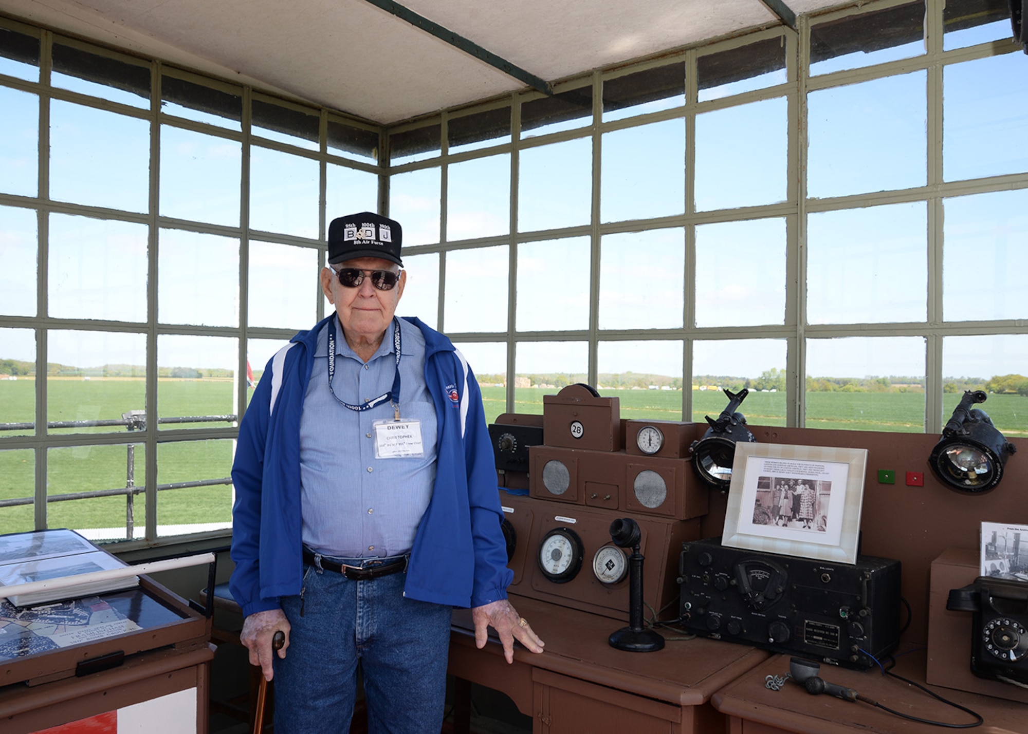 Master Sgt. (retired) Dewey Christopher, 100th Bombardment Group veteran and former B-17 crew chief, poses for a photograph May 10, 2017, in the old air traffic control tower at Parham Airfield Museum, England. Christopher and other 100th BG veterans, along with their families and other members of the 100th BG Foundation, joined 100th Air Refueling Wing members on a heritage trail visit of former World War II bases in East Anglia. (U.S. Air Force photo by Karen Abeyasekere)