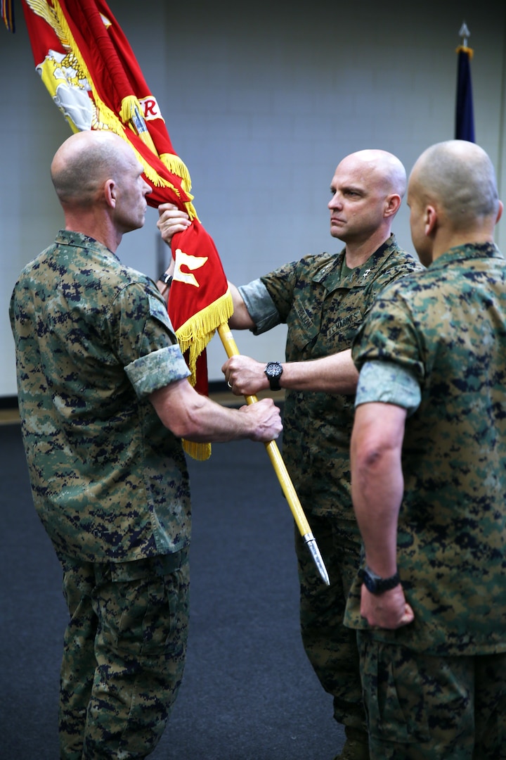 Brig. Gen. Kevin M. Iiams, the outgoing commander of U.S. Marine Corps Forces, South,  passes the unit colors to Maj. Gen. David G. Bellon during the unit's change of command ceremony in Doral, Florida, May 22, 2017. Iiams is set to become the next commander of U.S. Marine Corps Training and Education Command. (U.S. Marine Corps photo by Gunnery Sgt. Zachary Dyer)