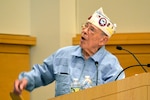 Les Cruise, a World War II veteran, relates stories of his experiences in Europe as a paratrooper with the 82nd Airborne Division, including the painful losses of his friends during combat, to the Naval Support Activity Philadelphia workforce during a Memorial Day observance May 18.