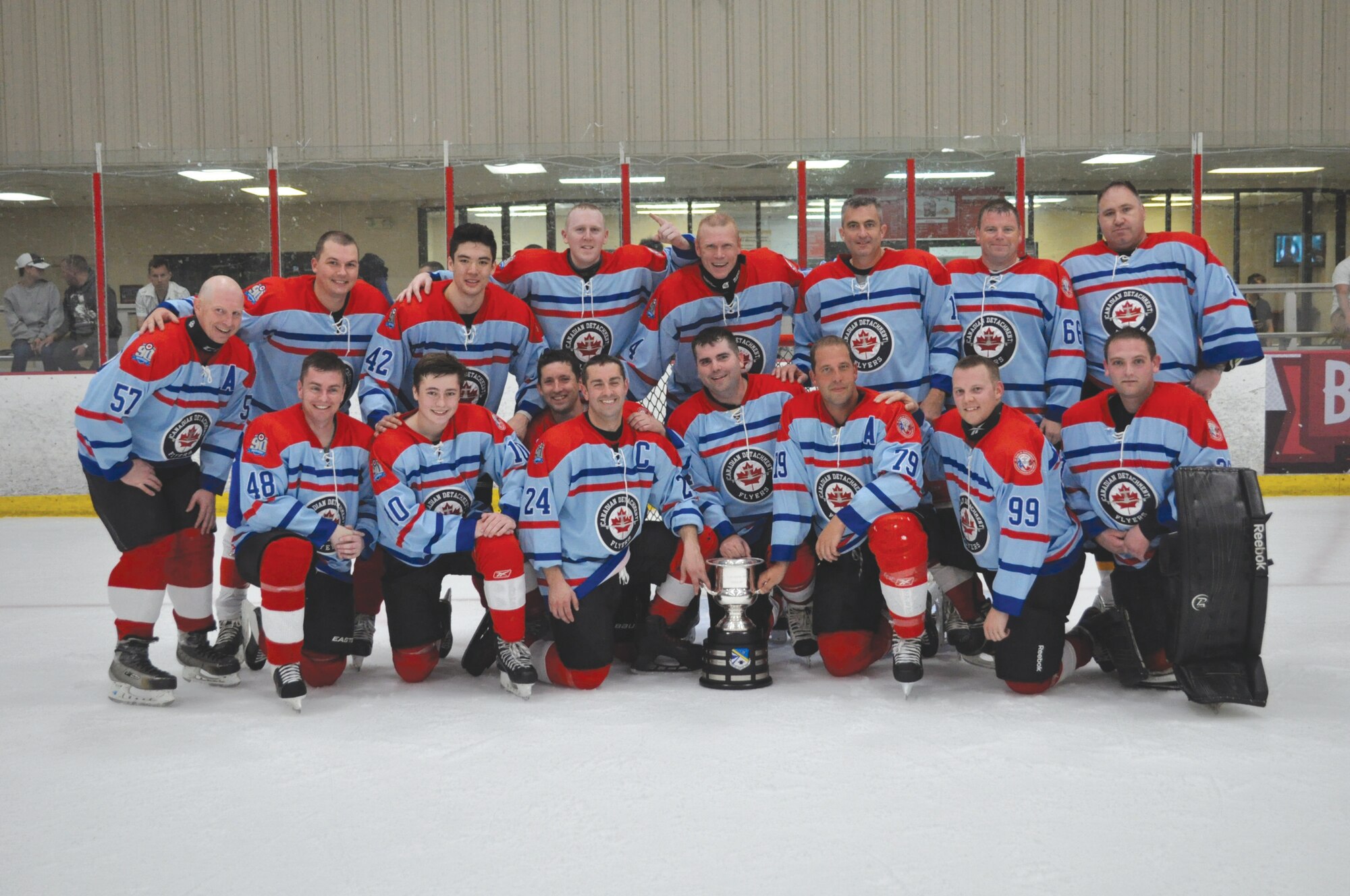 The 552nd Air Control Wing Canadian Detachment team lines up with the CAN/US Cup after defeating the Americans 5-1 in the ninth annual match-up at the Blazers Ice Center in Oklahoma City on May 12.  The series is now 6-3 Americans.