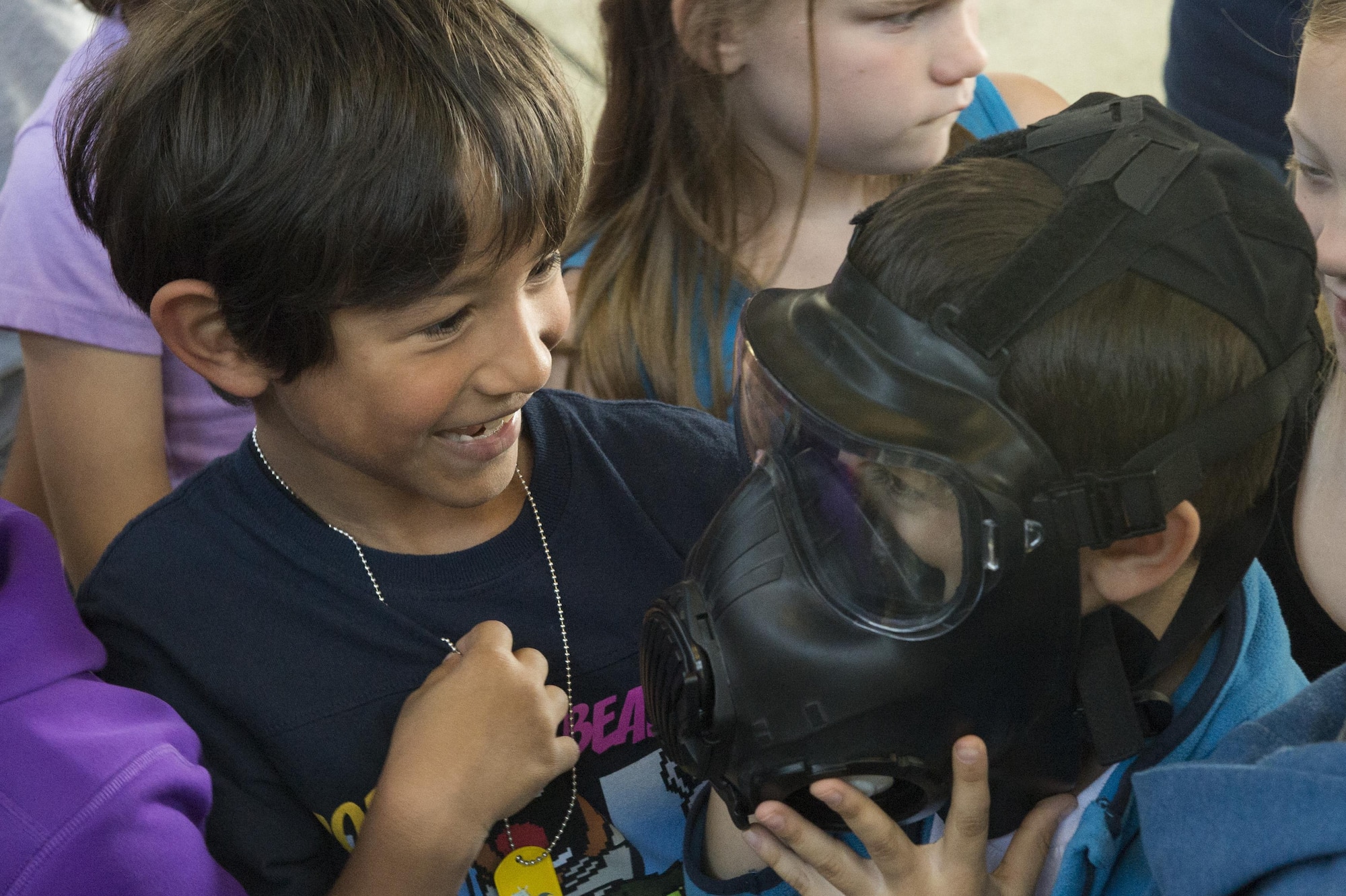 Spangdahlem Elementary School children try on deployment equipment during Children’s Deployment Days at Spangdahlem Air Base, Germany, May 22, 2017. Over the course of three days, different grades of elementary students experienced a mock deployment to better understand what their parents do before a deployment. (U.S. Air Force photo by Airman 1st Class Preston Cherry)