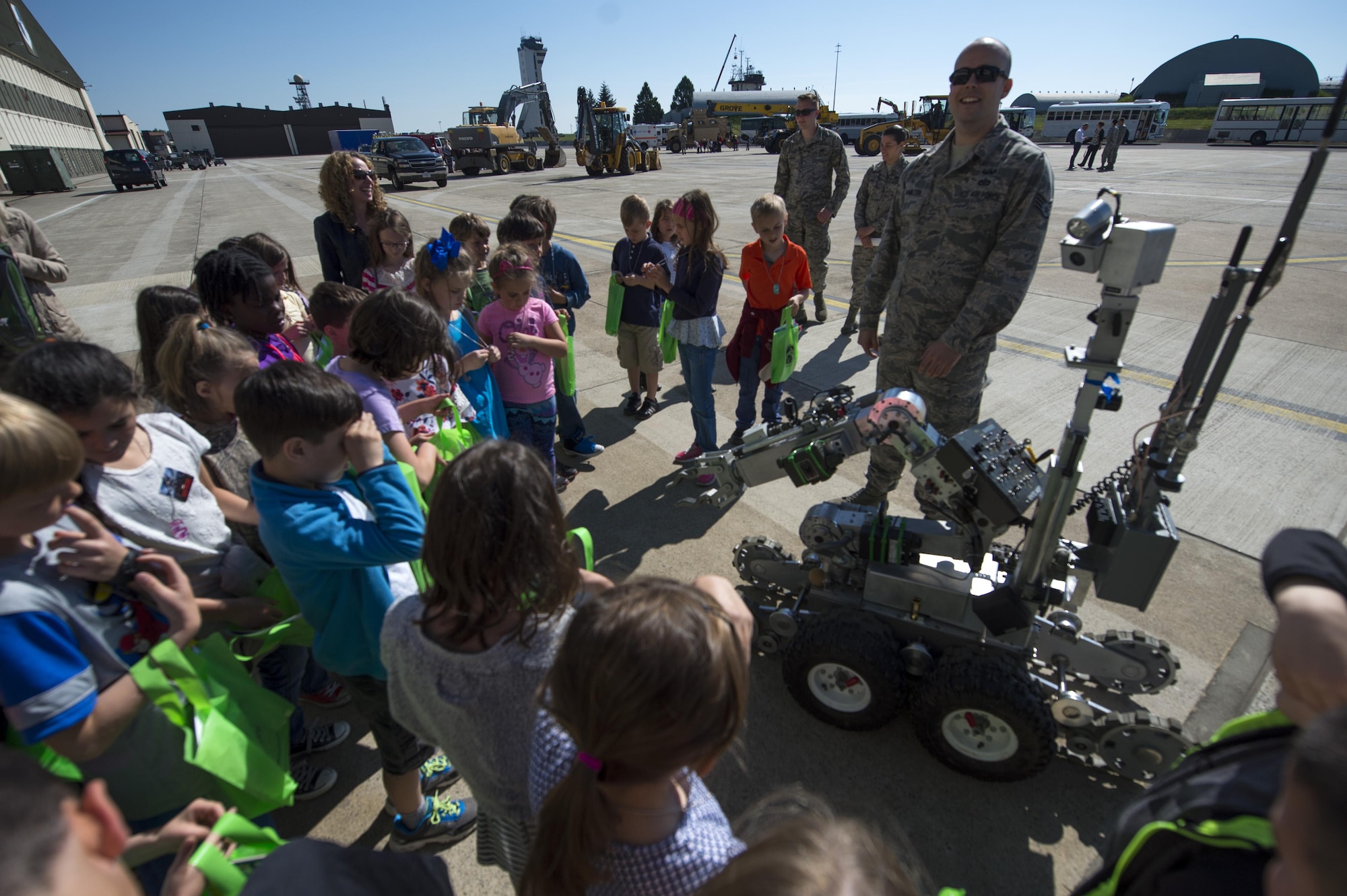 U.S. Air Force Staff Sgt. Brook Hamilton, 52nd Civil Engineer Squadron explosive ordnance disposal team member, shows children from Spangdahlem Elementary School an EOD robot during Children’s Deployment Days at Spangdahlem Air Base, Germany, May 22, 2017. The event helped children better understand a deployment and included a pre-deployment brief, individual protective equipment station and multiple static displays for children to learn about. (U.S. Air Force photo by Airman 1st Class Preston Cherry)