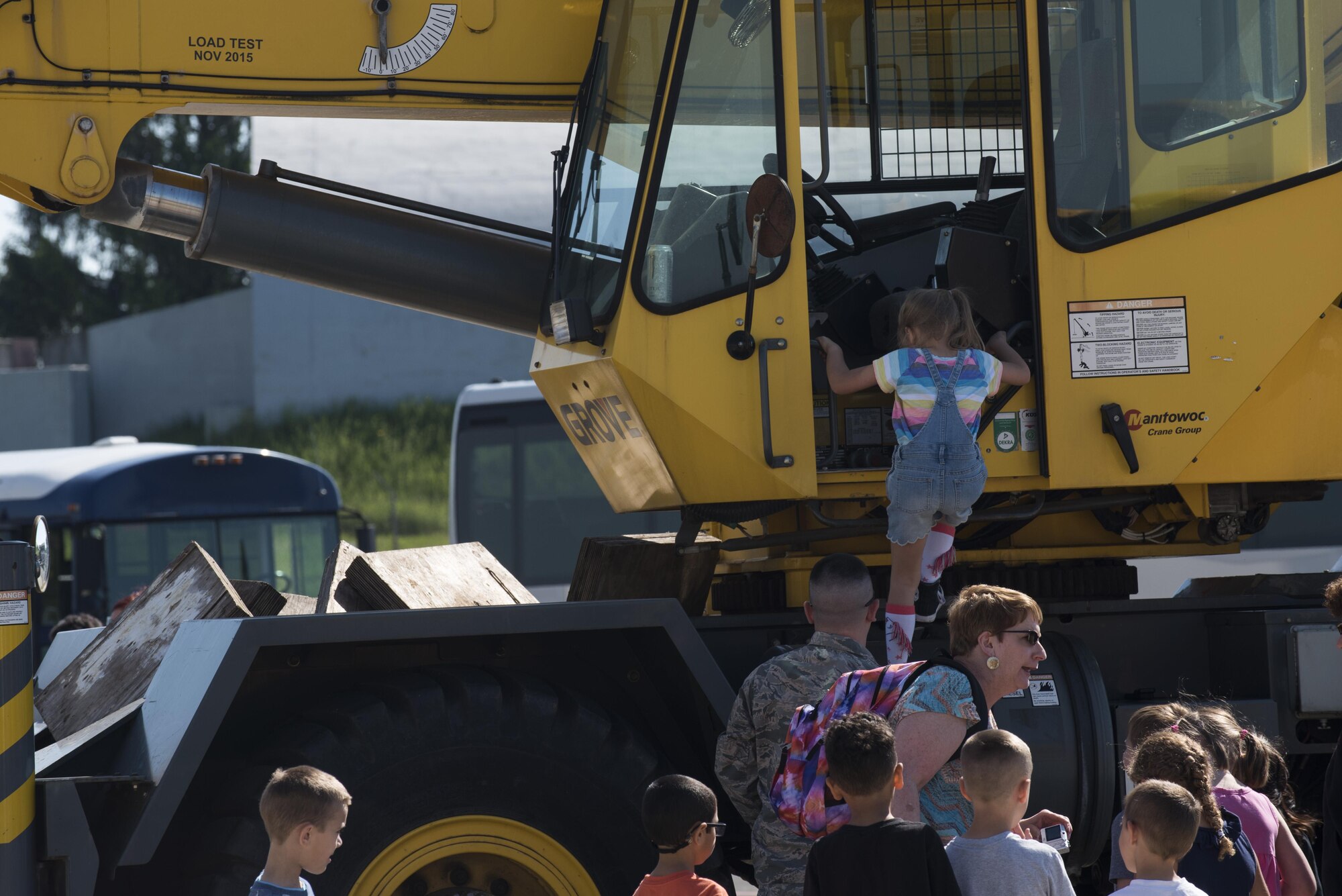 A Spangdahlem Elementary School student climbs into a 52nd Civil Engineer Squadron construction vehicle during Children’s Deployment Days at Spangdahlem Air Base, Germany, May 22, 2017. The event taught children the process of how their parents prepare to deploy for real-world operations. (U.S. Air Force photo by Airman 1st Class Preston Cherry)