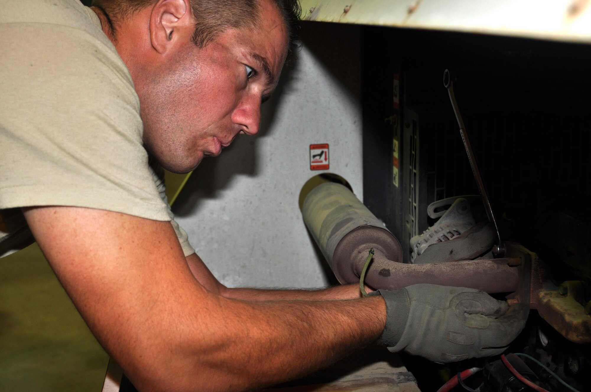 Staff Sergeant Jordan LeMay, the 386th Expeditionary Civil Engineer Squadron NCO in charge of light carts, loosens a rusted exhaust manifold bolt during a light cart teardown at the 386 ECES Power Production facility Wednesday, May 17, 2017.  This cart was being converted to run off of the base power grid. (U.S. Air Force photo/Master Sgt. Eric Sharman)