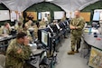 Master Sgt. Pierre Brudnicki, right, speaks to the battle staff Friday, May 12, 2017 during the 7th Mission Support Command's Command Post Exercise at Panzer Kaserne in Kaiserslautern. 
