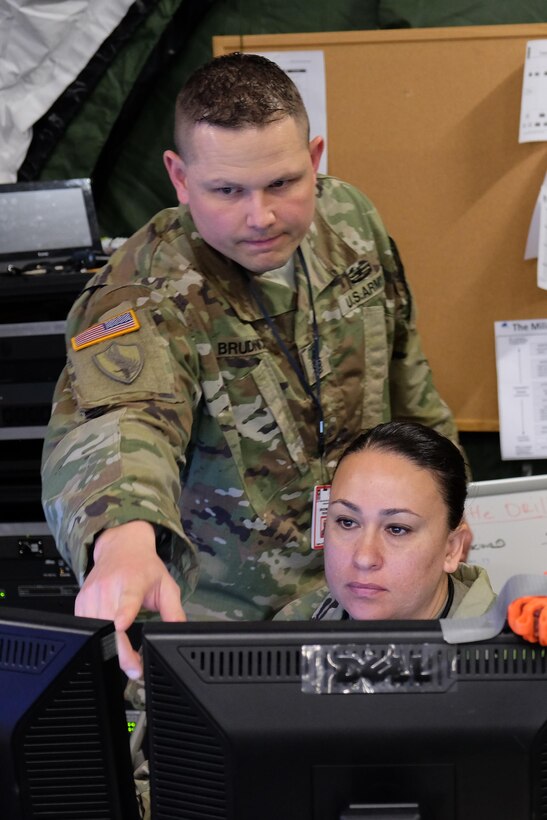 Master Sgt. Pierre Brudnicki, left, and Sgt. 1st Class Brenda Vejar input material into the Command Post of the Future computer system Saturday, May 13, 2017 during the 7th Mission Support Command's Command Post Exercise at Panzer Kaserne in Kaiserslautern. 