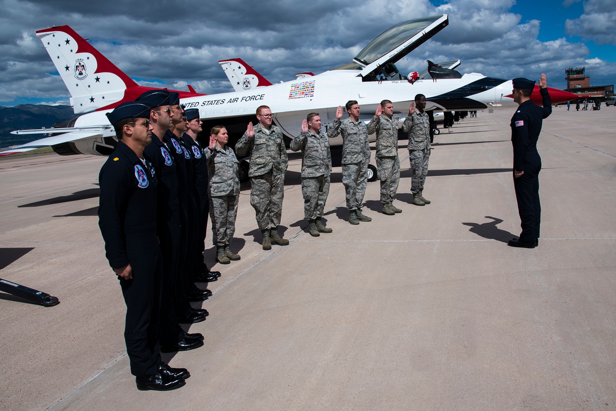 Lt. Col. Jason Heard, Thunderbird Air Demonstration Squadron commander, reenlists Airmen from the 21st Space Wing, United States Air Force Academy, Air Force Space Command and Schriever Air Station at Peterson Air Force Base, Colo., May 23, 2017. The Thunderbirds make it a point to reenlist Airmen with every visit to Peterson AFB. (U.S. Air Force photo by Robb Lingley) 