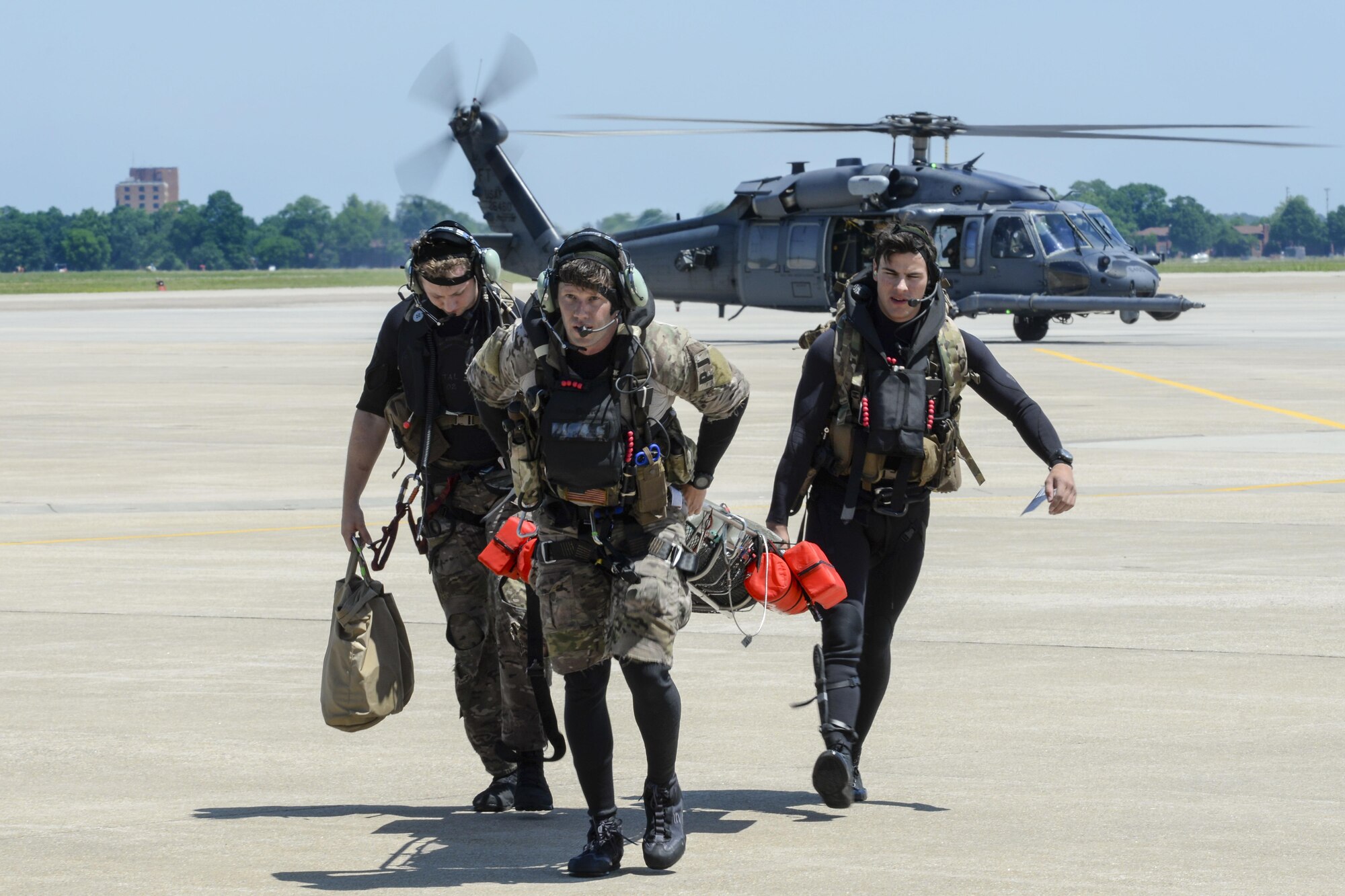From left, Staff Sgt. Robert Hall, Staff Sgt. Travis Lester, and Senior Airman Eddie Judge, all 38th Rescue Squadron pararescuemen assigned to Moody Air Force Base, Ga., carry an Airman with simulated injuries toward a 3rd Airlift Squadron C-17 Globemaster III, May 17, 2017, during Exercise Rapid Rescue at Joint Base Langley-Eustis, Va. The C-17 was prepped and ready to takeoff for a simulated aeromedical evacuation flight when the search and rescue team arrived. (U.S. Air Force photo/Senior Airman Aaron J. Jenne)