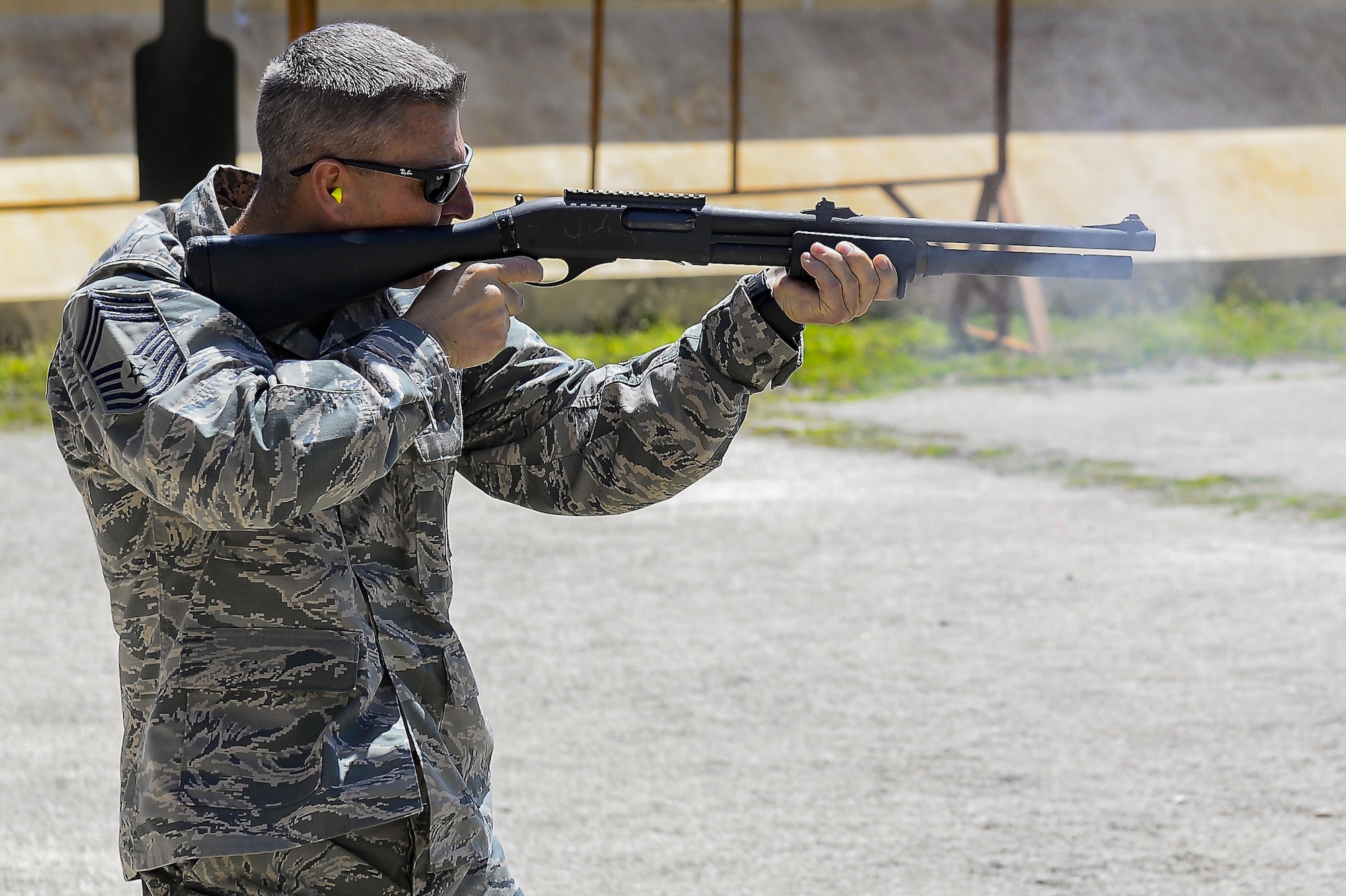Chief Master Sgt. Jammie Space, a 36th Security Forces Squadron security forces manager, fires an M870 Modular Combat Shotgun during the leadership competition shoot off May 18, 2017,  at Andersen Air Force Base, Guam. The event was part of National Police Week which recognized the service and sacrifice of law enforcement officers. (U.S. Air Force photo/Airman 1st Class Christopher Quail)