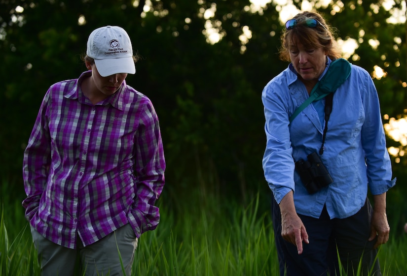 Karen Terwilliger, a local environmental expert, points out an ideal Diamondback Terrapin Turtle nesting place to Alicia Garcia, Colorado State University natural resource program manager for Langley AFB, at a brackish water marsh at Joint Base Langley-Eustis, Va., May 10, 2017. Langley Air Force Base’s shoreline, 3,000 linear feet of which was restored, is an ideal nesting place for the Diamonback Terrapin. (U.S. Air Force photo by Staff Sgt. Natasha Stannard)