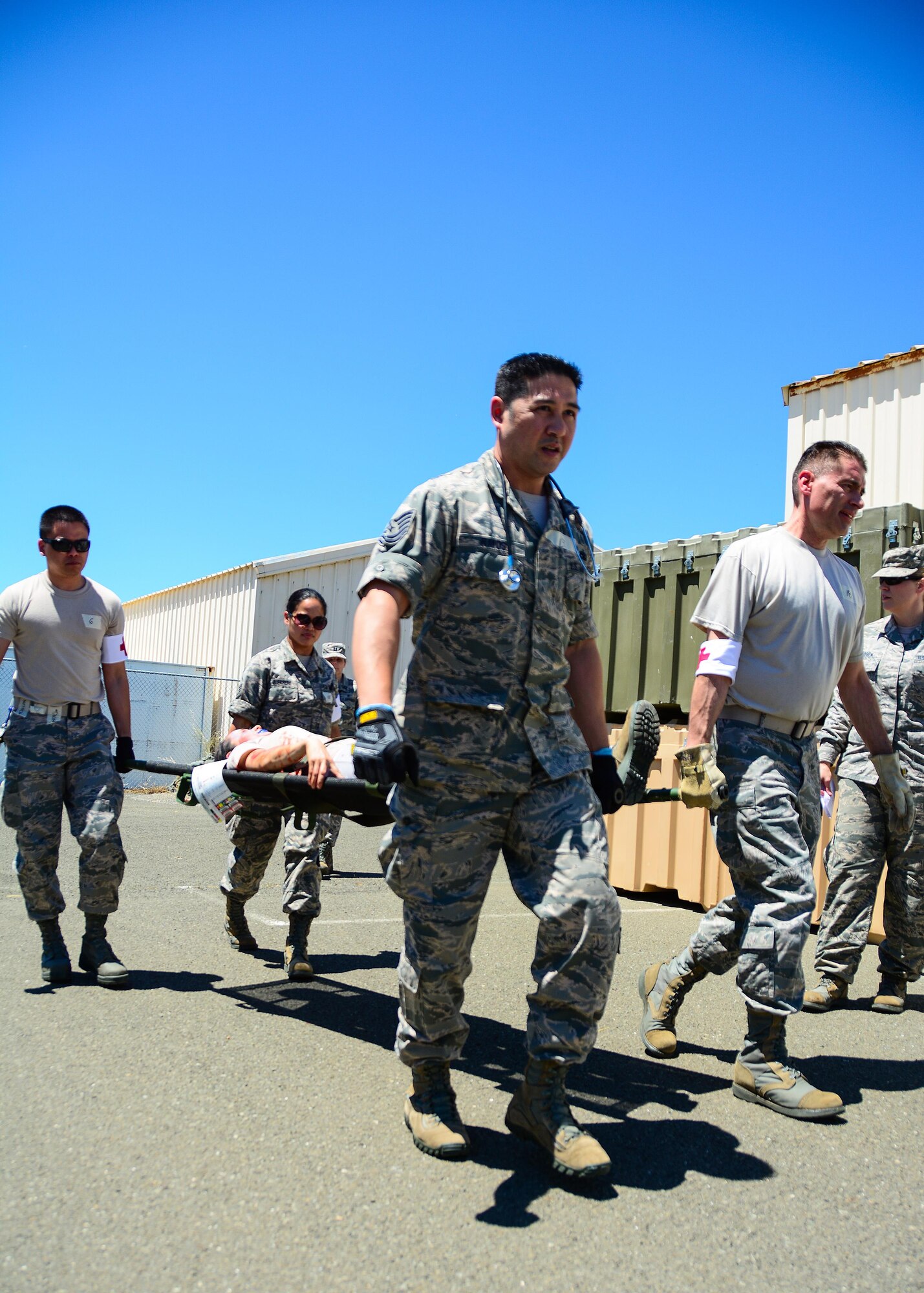 Air Force Reservists and Guardsmen from the 349th and 129th Medical Groups transport a moulaged patient by litter carry during a mass causalty scenario at Travis Air Force Base, Calif., on May 19, 2017. The 349th MDG held a week-long training session for medical Airmen that culminated in a mass casualty exercise. (U.S. Air Force photo/Staff Sgt. Daniel Phelps)