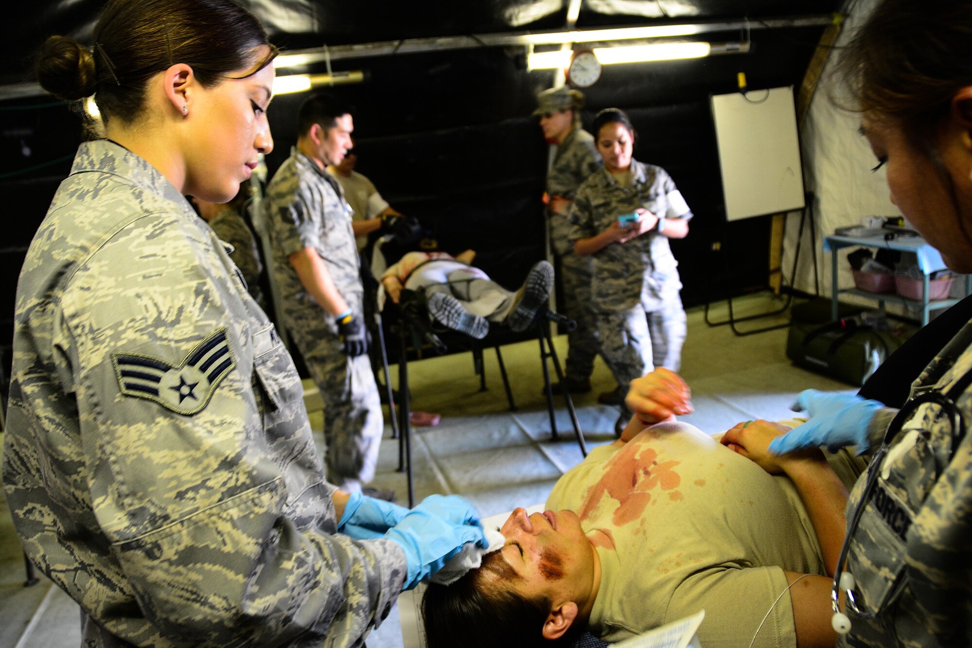Senior Airman Cynthia Moreno, 349th Aeromedical Staging Squadron medical technician, provides patient care to 2nd Lt. Rocio Arevalo, 129th Medical Group nurse, during a mass casualty exercise at Travis Air Force Base, Calif., on May 19, 2017. The 349th Medical Group conducted a medical training course for members of the 349th and 129th MDGs that culiminated in a mass casualty training scenario. (U.S. Air Force photo/Staff Sgt. Daniel Phelps)