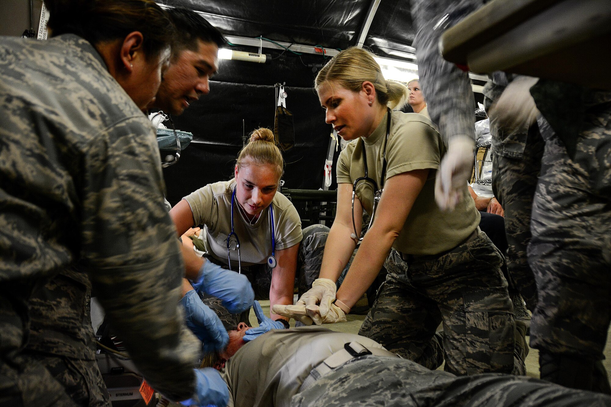 Medical Airmen administer life-saving manuevers on moulaged "patient" during a mass casulaty training exercise at Travis Air Force Base, Calif., on May 19, 2017. The 349th Medical Group conducted a week-long medical training course for the 349th and 129th MDGs that culminated in a mass casualty training scenario. (U.S. Air Force photo/Staff Sgt. Daniel Phelps)