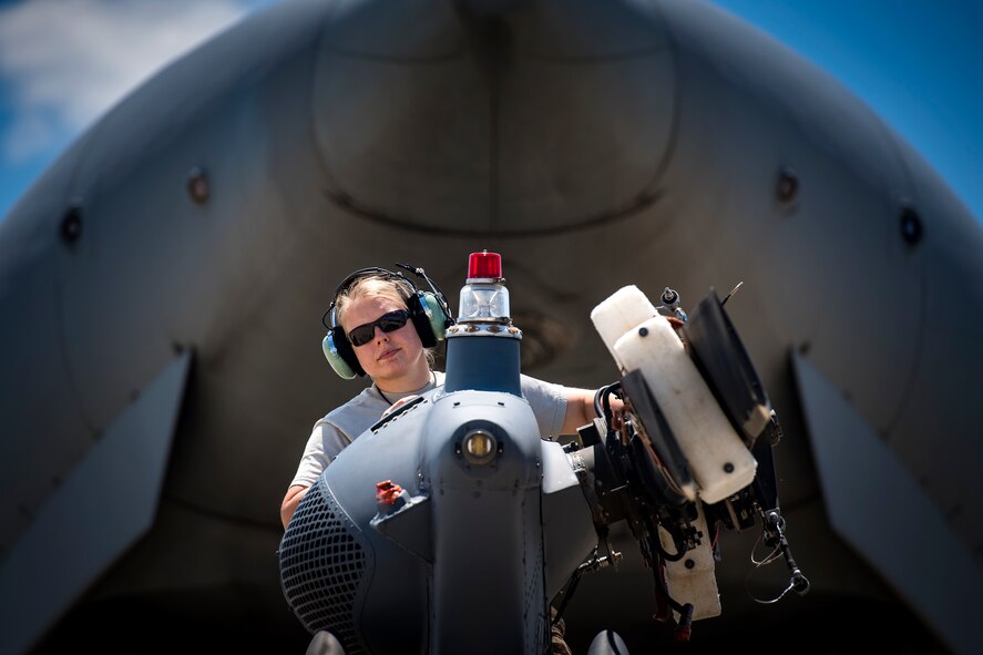 An Airman from the 41st Helicopter Maintenance Unit stands on top of an HH-60G Pave Hawk, May 15, 2017, at Moody Air Force Base, Ga. While loading the helicopter into a large transport aircraft, an airman will ride on the tail to ensure there is no contact between the aircraft. (U.S. Air Force photo by Staff Sgt. Ryan Callaghan)